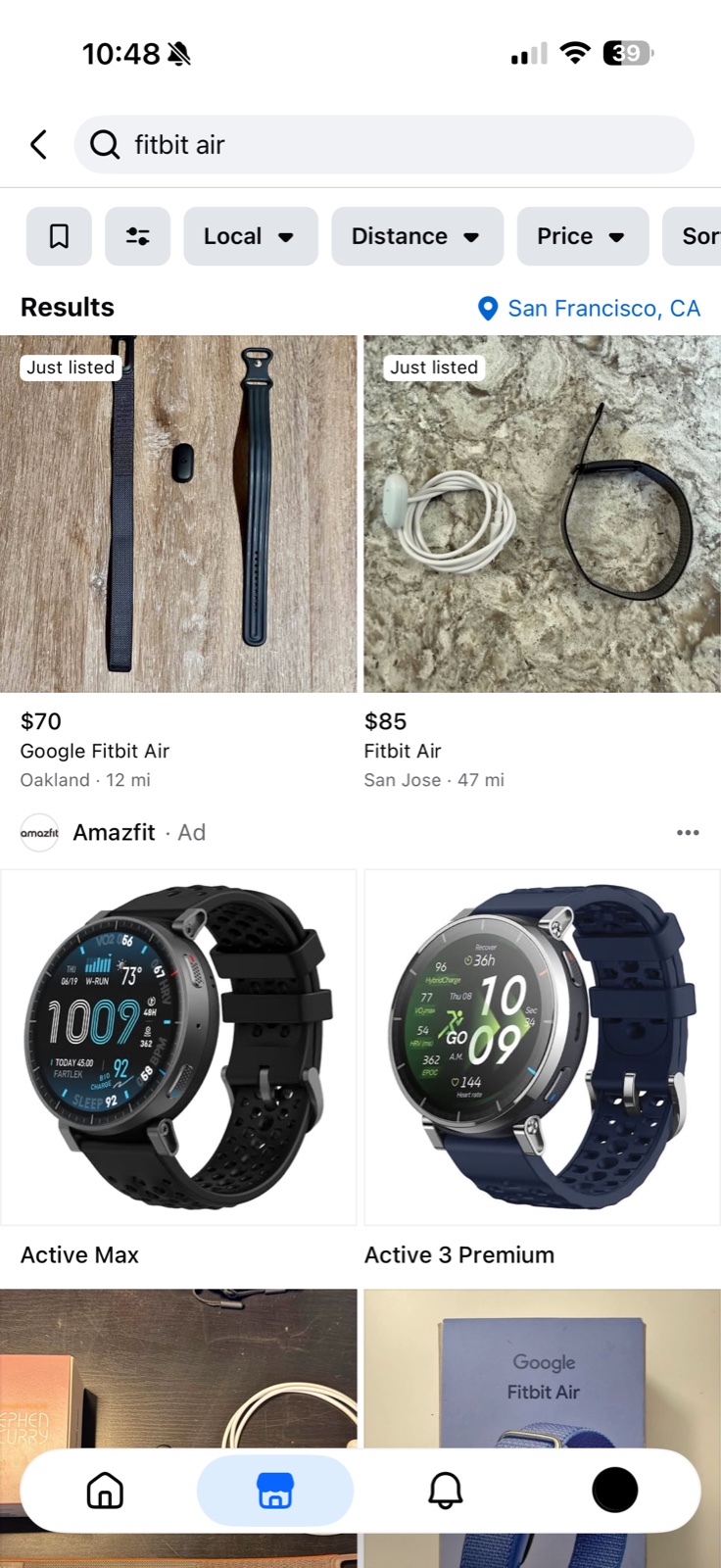 Marketplace search results showing two listings with mileage labels followed by a labelled Amazfit advertisement occupying a full row